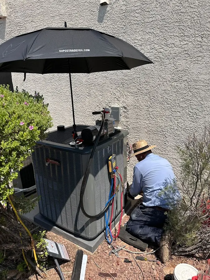 HVAC technician performing outdoor AC maintenance in Finley
